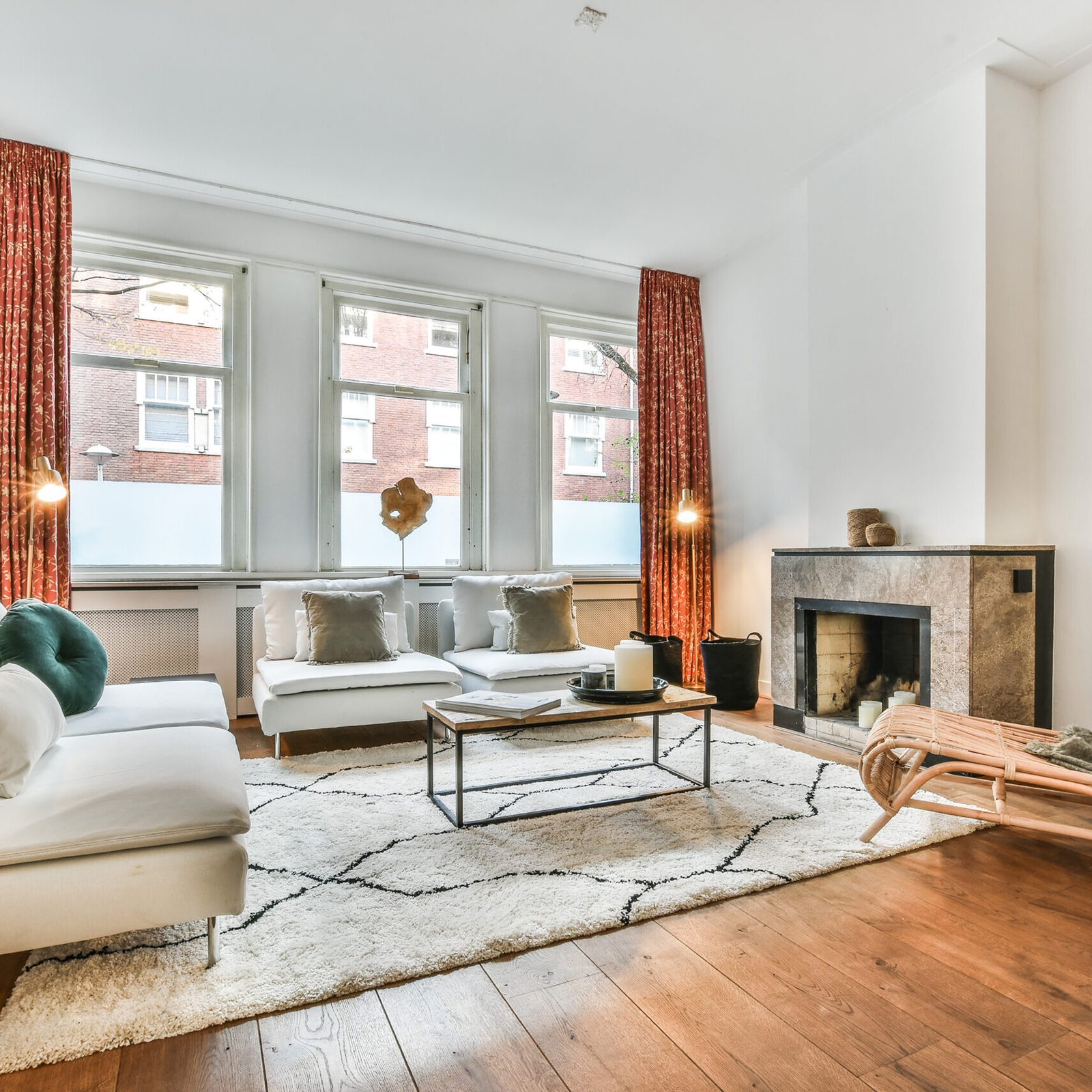 Interior of spacious lounge with fireplace and comfortable sofa and armchairs in contemporary house